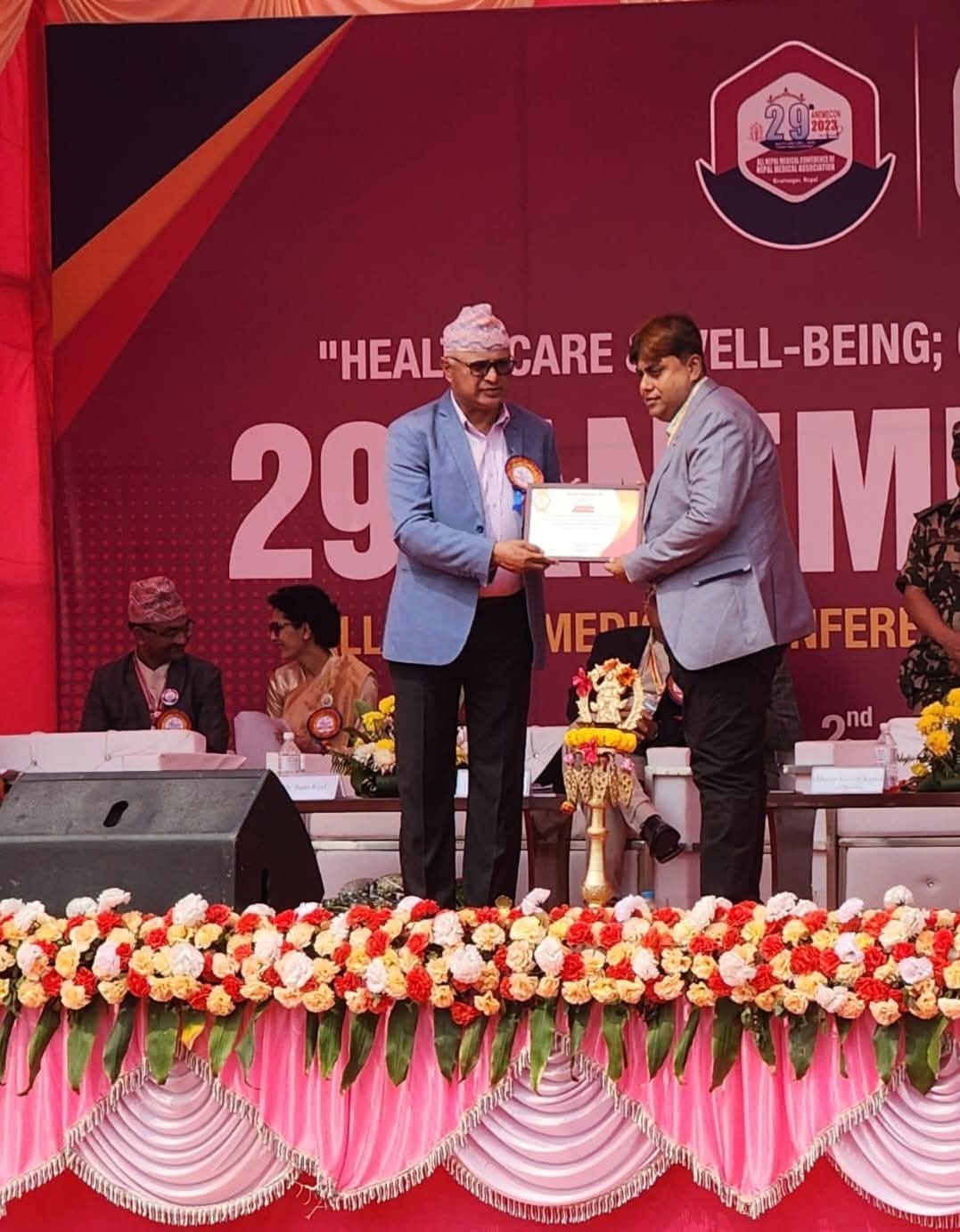 Dr. Niraj Kumar Singh receiving a certificate on the main stage of the 29th All Nepal Medical Conference in Biratnagar, March 2023.